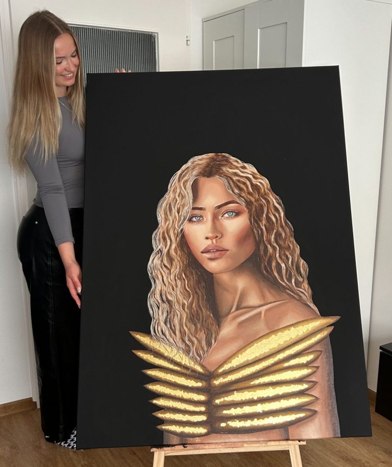 Auf diesem Bild sieht man die Künstlerin Hanna mit ihrem Golden Wings Gemälde